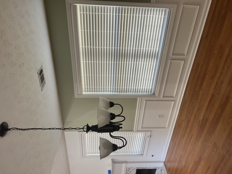 blinds in dining room with wainscoting
