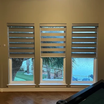 White window shutters with adjustable louvers in Suwanee bedroom