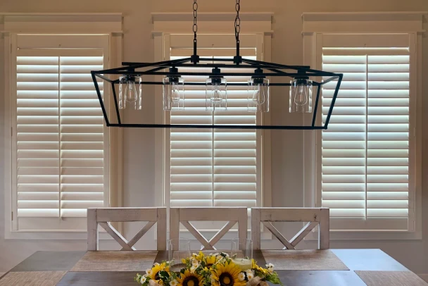 white plantation shutters in elegant bedroom setting